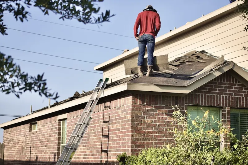 Professional roofer working on a residential roof in Gun Plain
